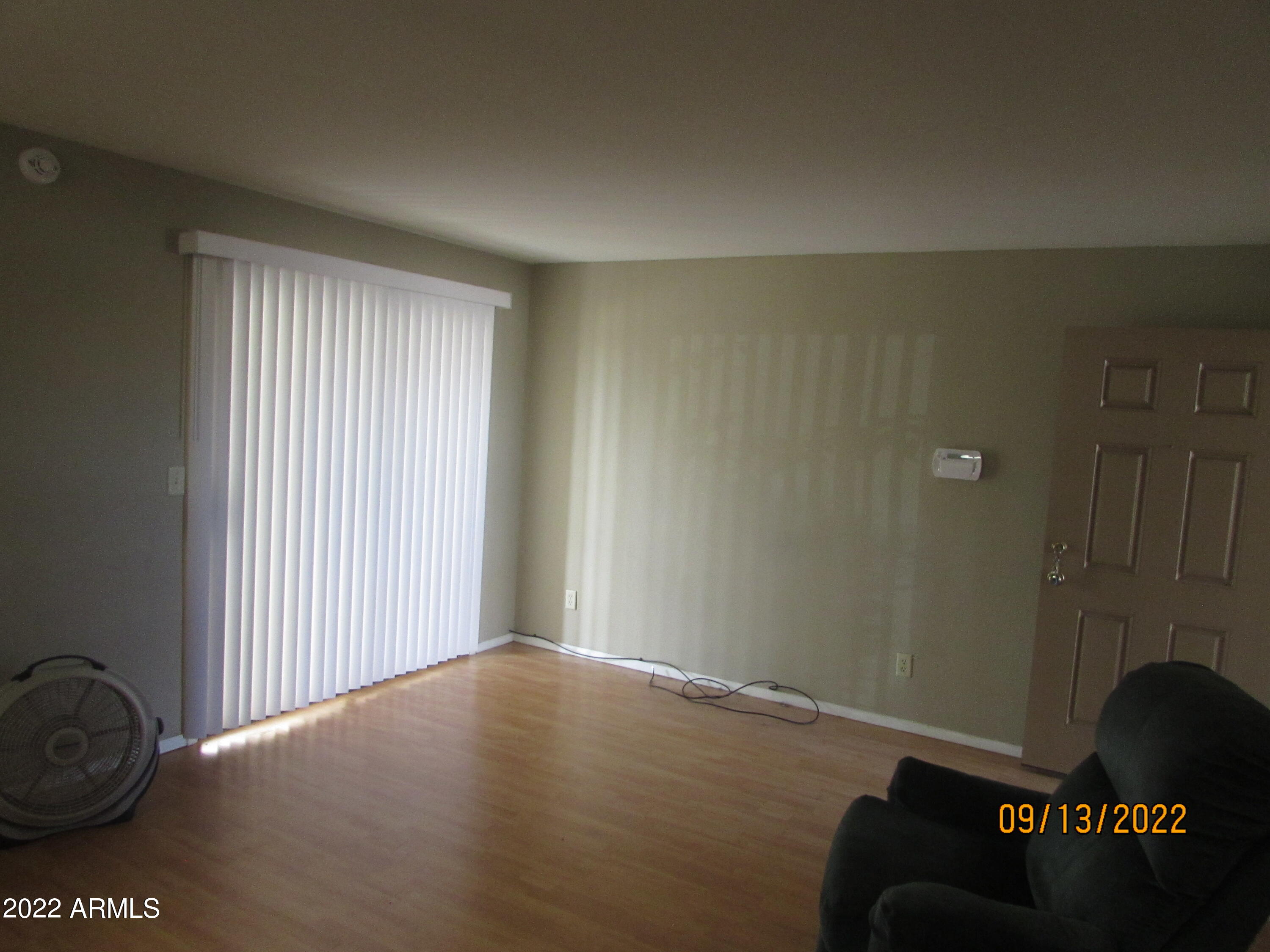 5236 West Peoria Avenue, Unit 115 Glendale, AZ 85302 - Photo 14 of 19 a view of a livingroom with wooden floor and a window