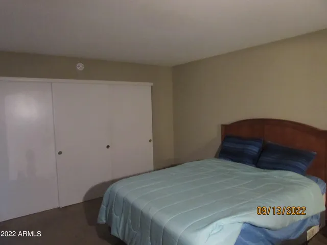 a bedroom with a bed and a night stand