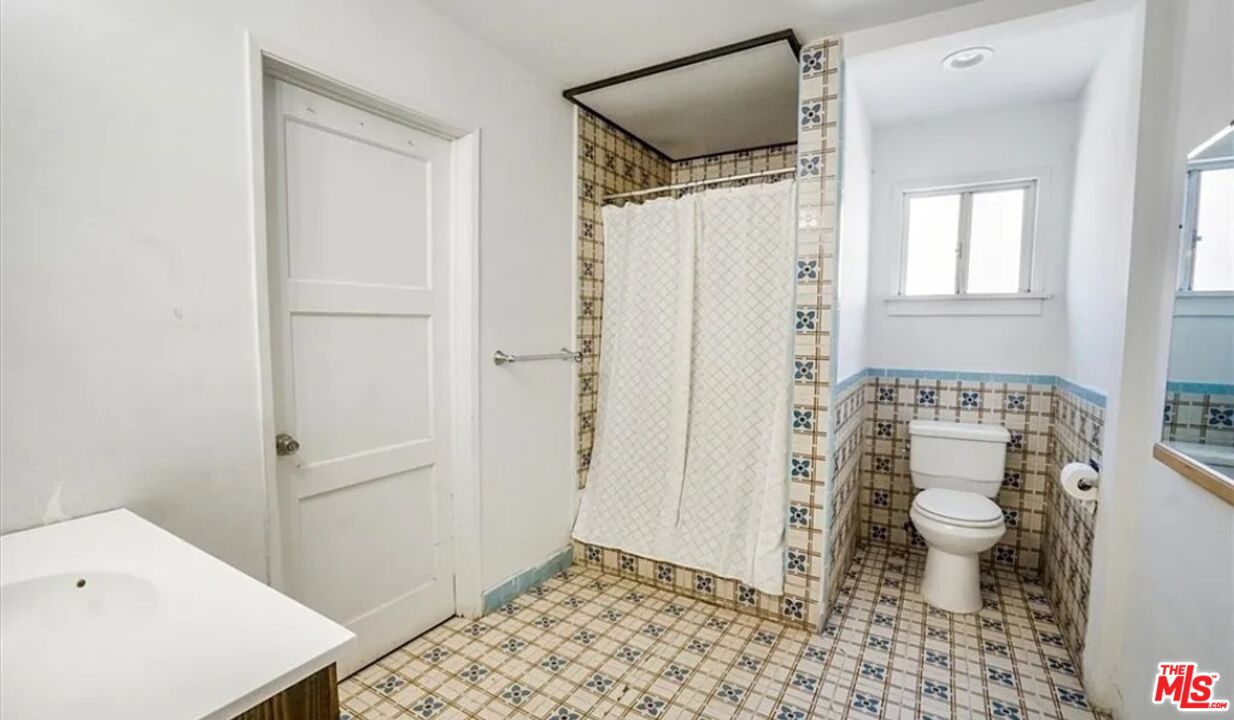 2010 East 122nd Street Compton, CA 90222 - Photo 11 of 28 a bathroom with a toilet and a shower