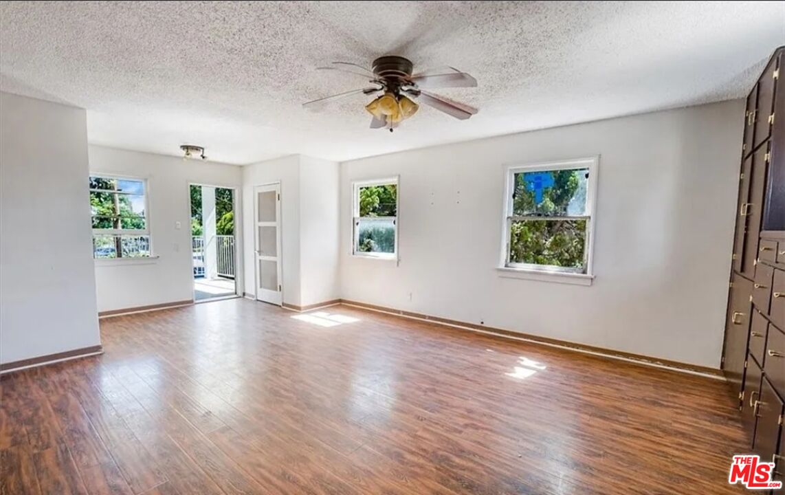 2010 East 122nd Street Compton, CA 90222 - Photo 16 of 28 a view of an empty room with a window and wooden floor