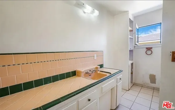 a kitchen with a sink and cabinets