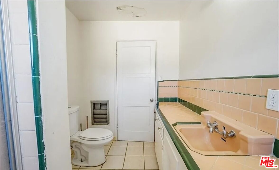 2010 East 122nd Street Compton, CA 90222 - Photo 22 of 28 a bathroom with a granite countertop sink toilet and shower