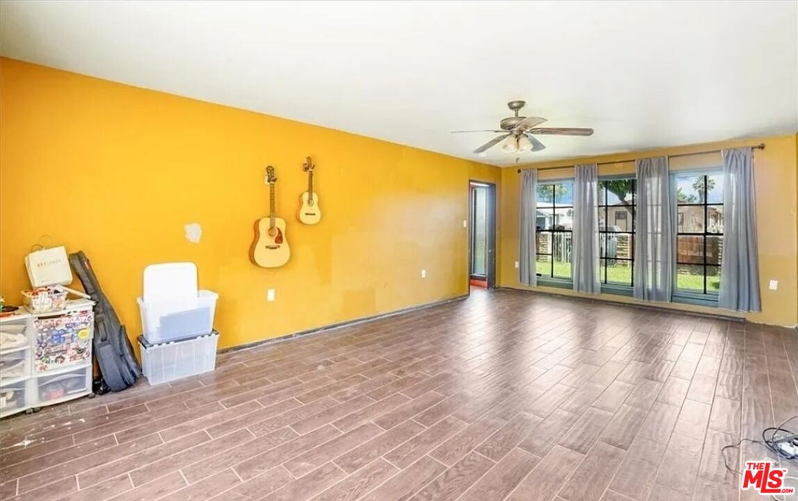 2010 East 122nd Street Compton, CA 90222 - Photo 4 of 28 a view of a livingroom with wooden floor and a ceiling fan