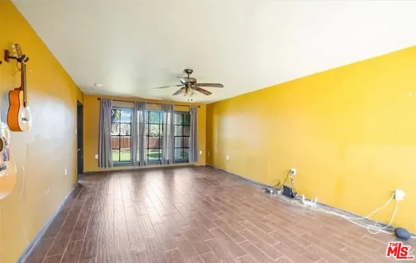 a view of hallway with wooden floor and chandelier