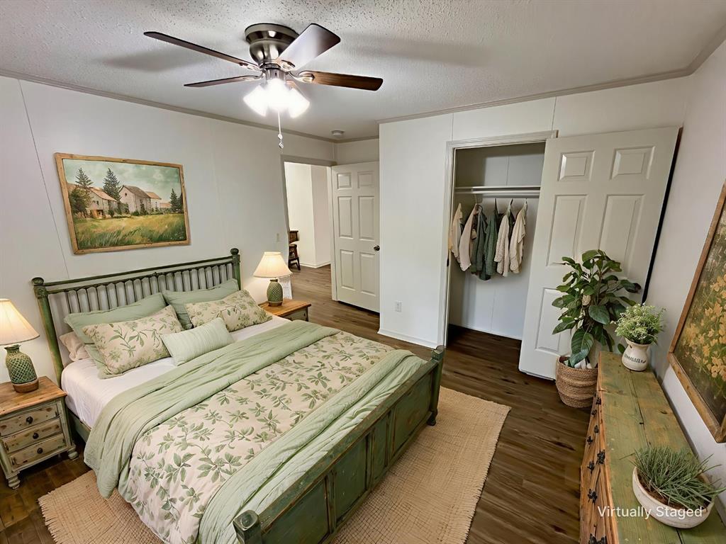 6913 Rice Road Shreveport, LA 71129 - Photo 9 of 26 a spacious bedroom with a bed and a chandelier