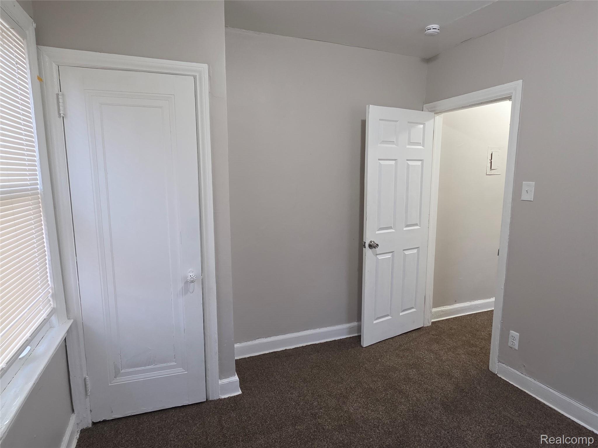 5274 Nottingham Road Detroit, MI 48224 - Photo 8 of 18 Unfurnished bedroom with dark carpet and baseboards