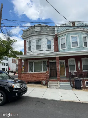 a front view of a house with parking space