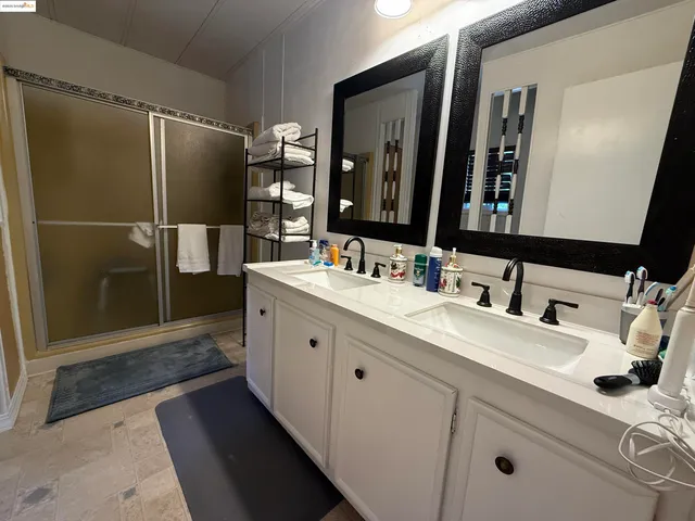 a bathroom with a double vanity sink and a mirror