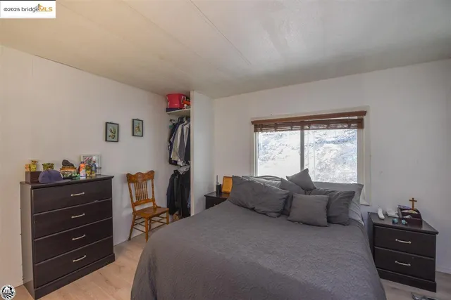 a bedroom with a bed and a tv