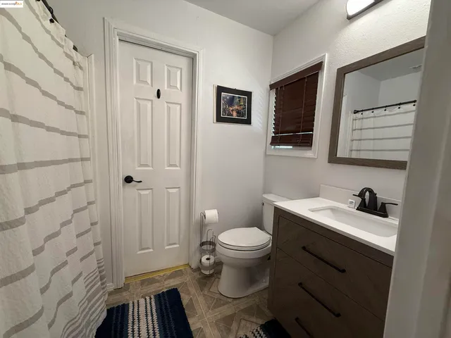 a view of washer and dryer with kitchen view