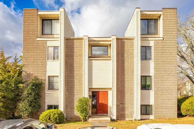 a view of a brick house with a large windows