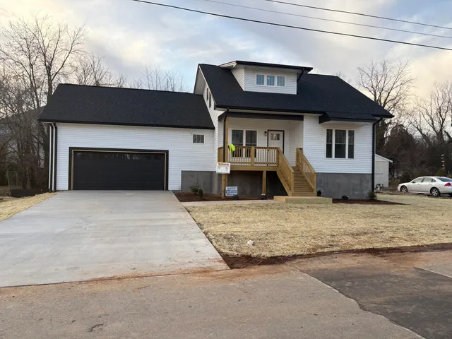 a front view of a house with yard and garage