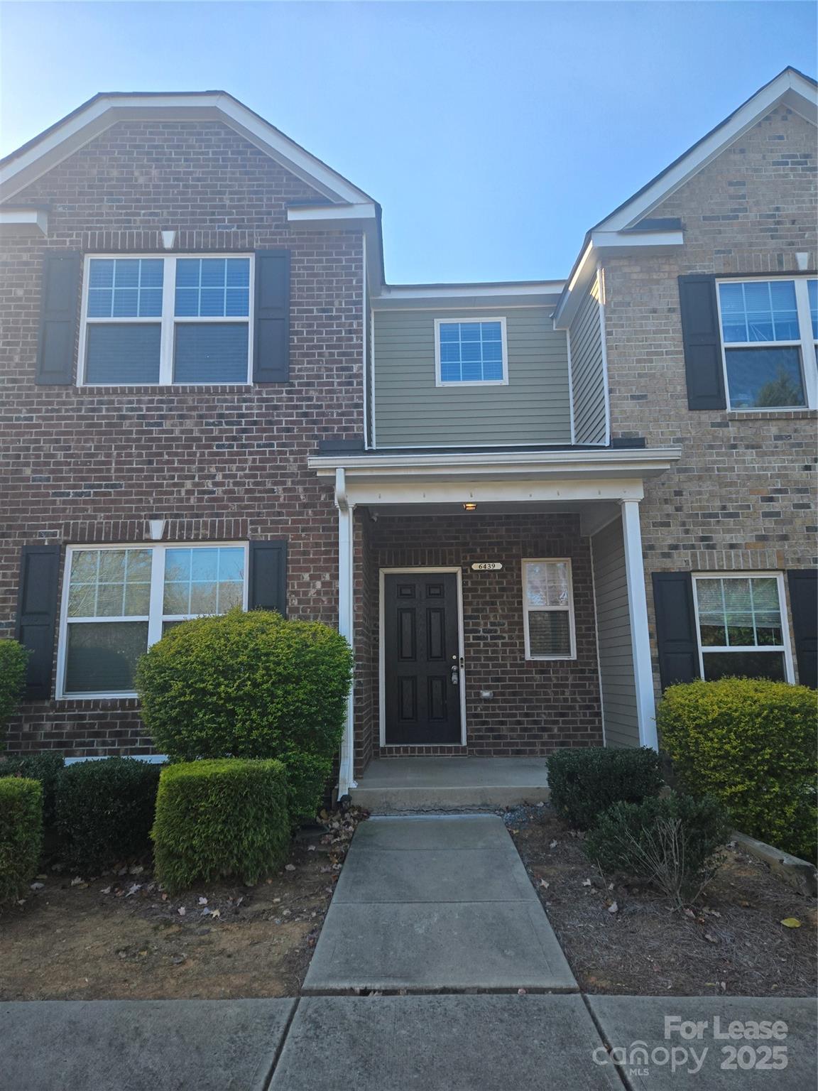 6439 Prosperity Church Road Charlotte, NC 28269 - Photo 1 of 12 a front view of a house with a yard and garage