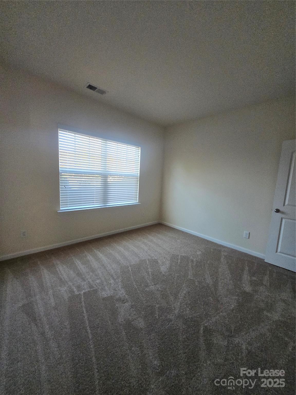 6439 Prosperity Church Road Charlotte, NC 28269 - Photo 11 of 12 a view of a room that has a window in it