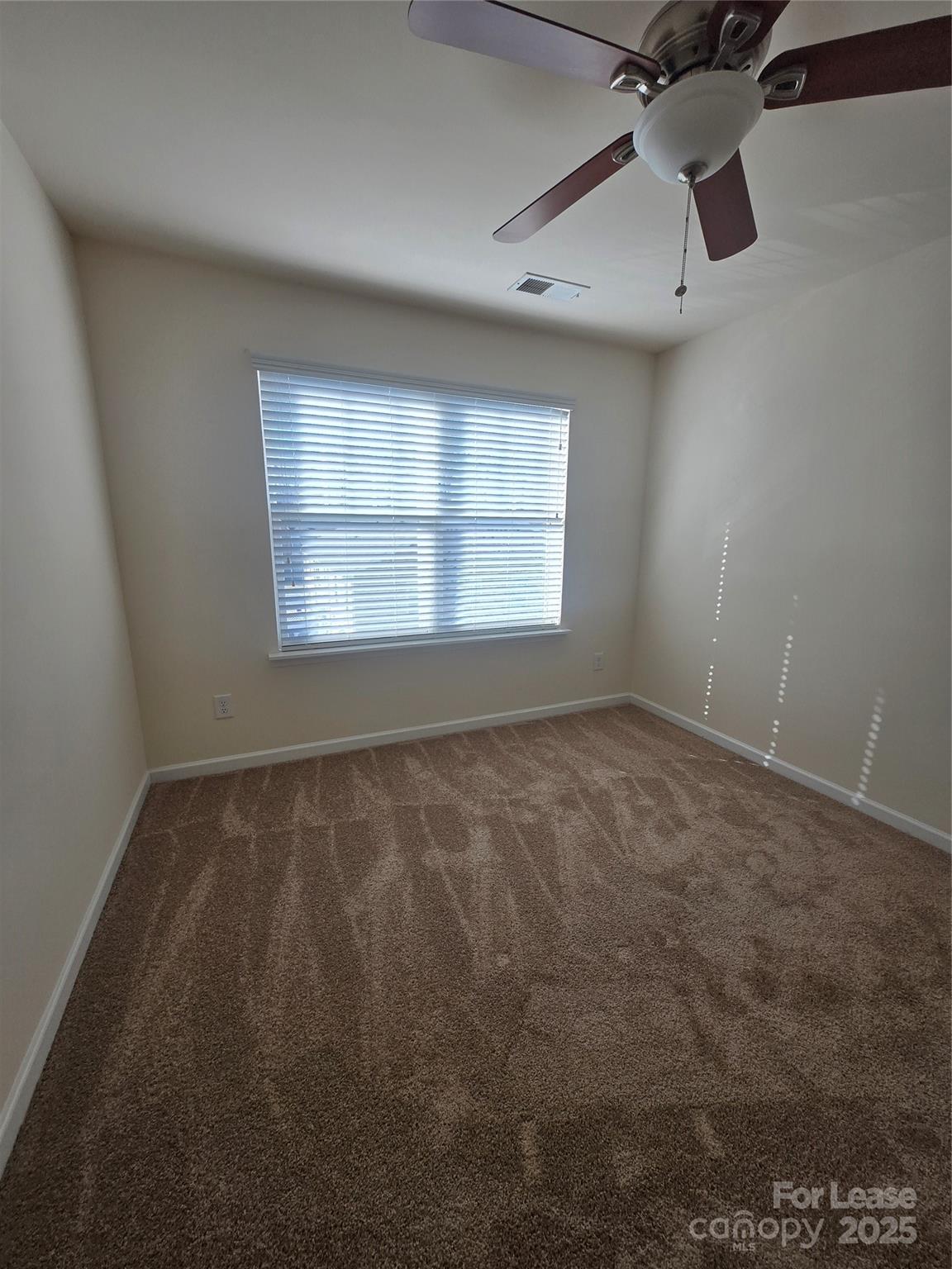 6439 Prosperity Church Road Charlotte, NC 28269 - Photo 7 of 12 an empty room with a window