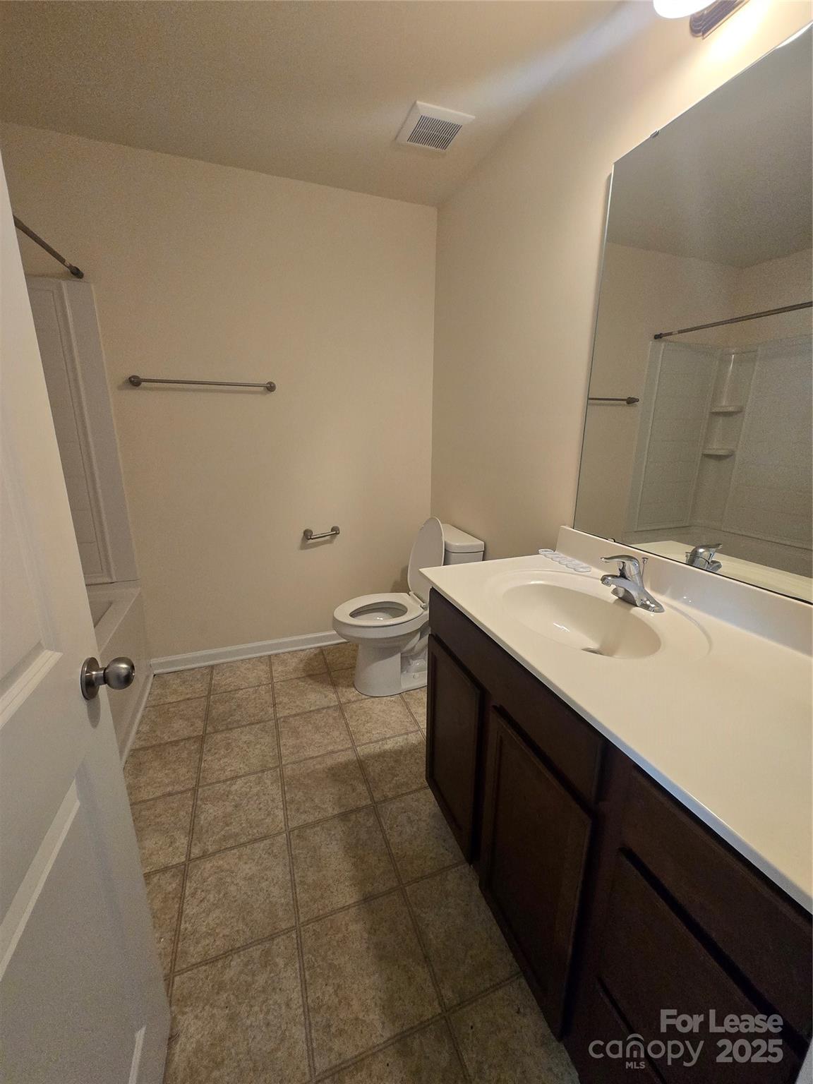 6439 Prosperity Church Road Charlotte, NC 28269 - Photo 9 of 12 a bathroom with a sink a toilet and a mirror