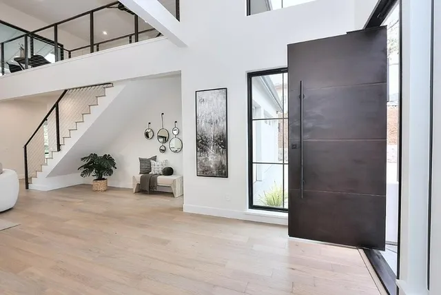 a kitchen with kitchen island a stove a sink a refrigerator and cabinets with wooden floor