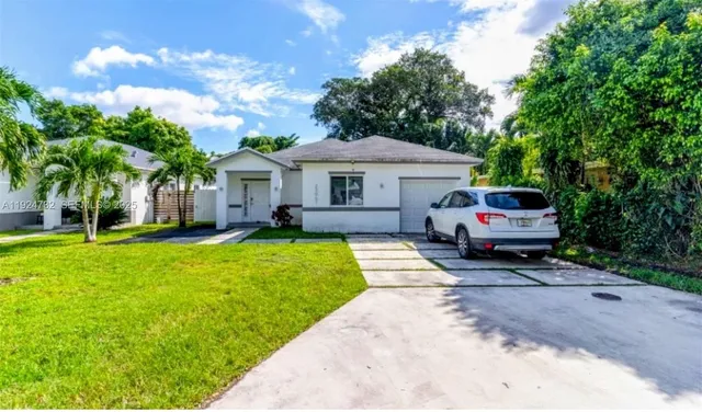 a front view of a house with a garden and porch