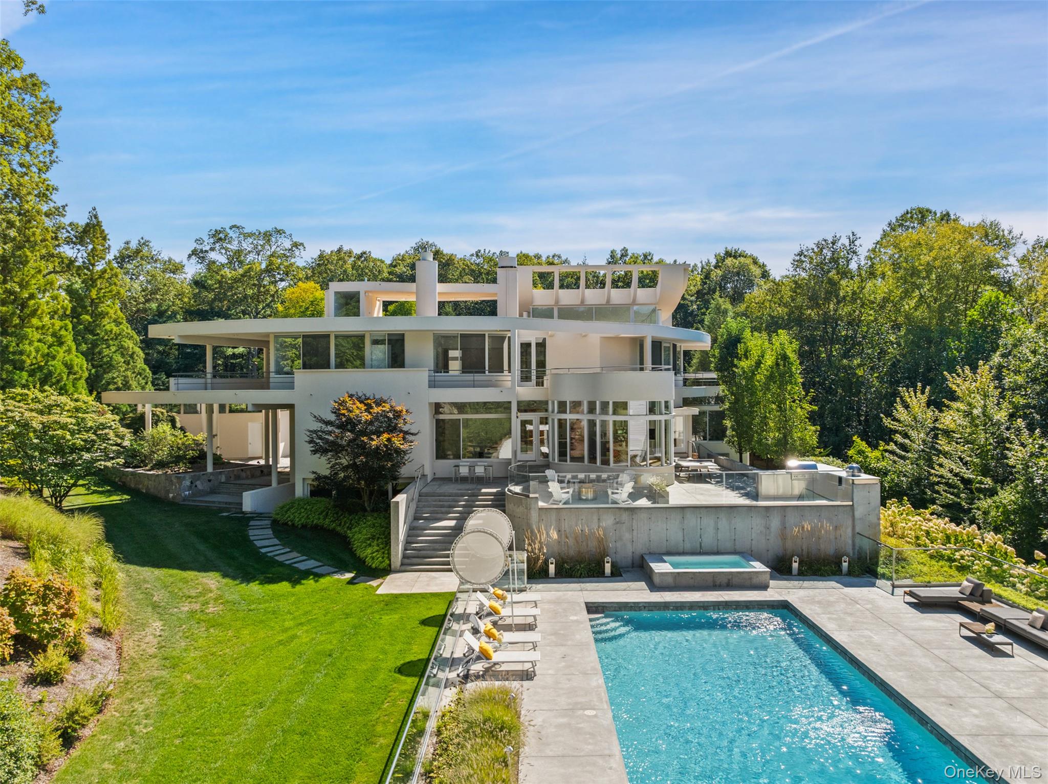 an aerial view of a house with swimming pool garden and patio