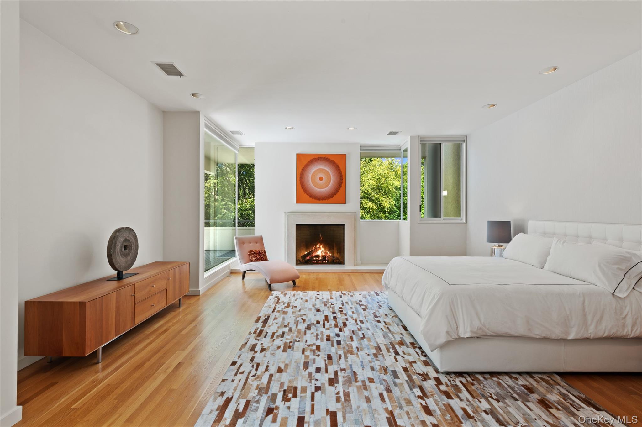 25 Col Sheldon Lane Pound Ridge, NY 10576 - Photo 17 of 34 a bedroom with a bed and a fireplace