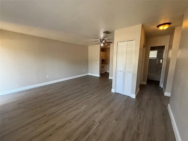 a view of a hallway with wooden floor