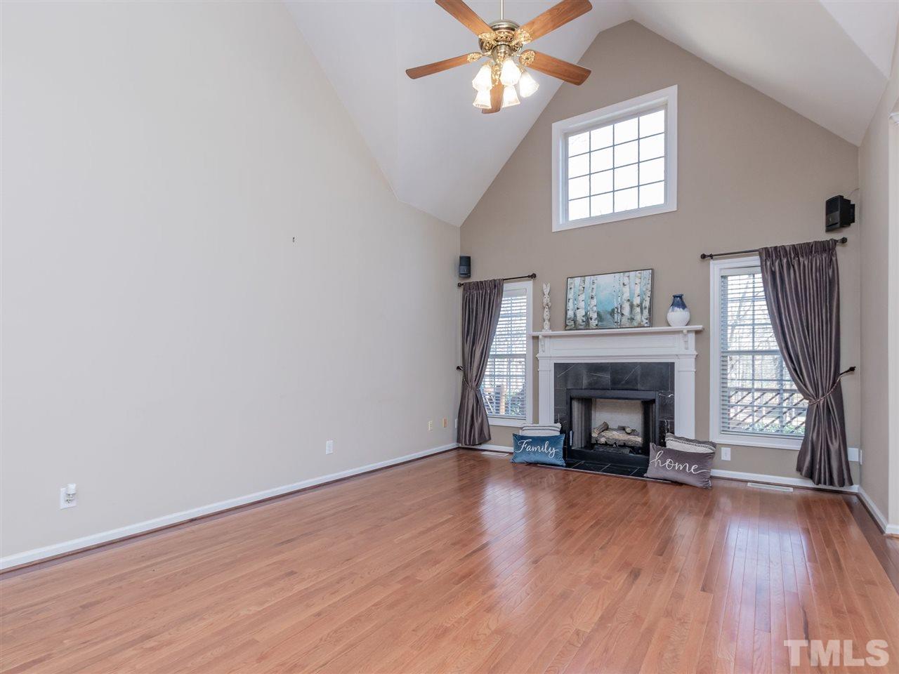 2864 Anfield Road Raleigh, NC 27606 - Photo 9 of 30 Two story family with fireplace and wood flooring. Notice all the fans in this home!