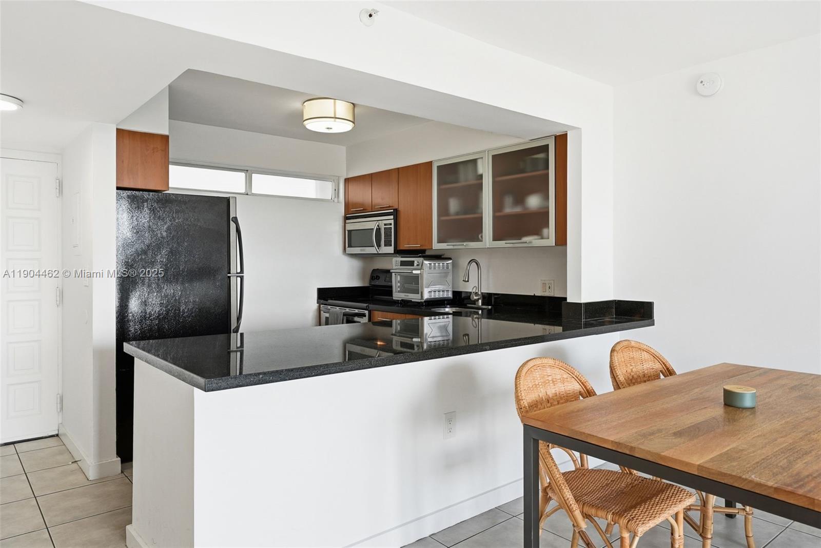 700 Northeast 63rd Street, Unit D607 Miami, FL 33138 - Photo 17 of 29 a kitchen with stainless steel appliances granite countertop a refrigerator a stove and a sink with granite countertops