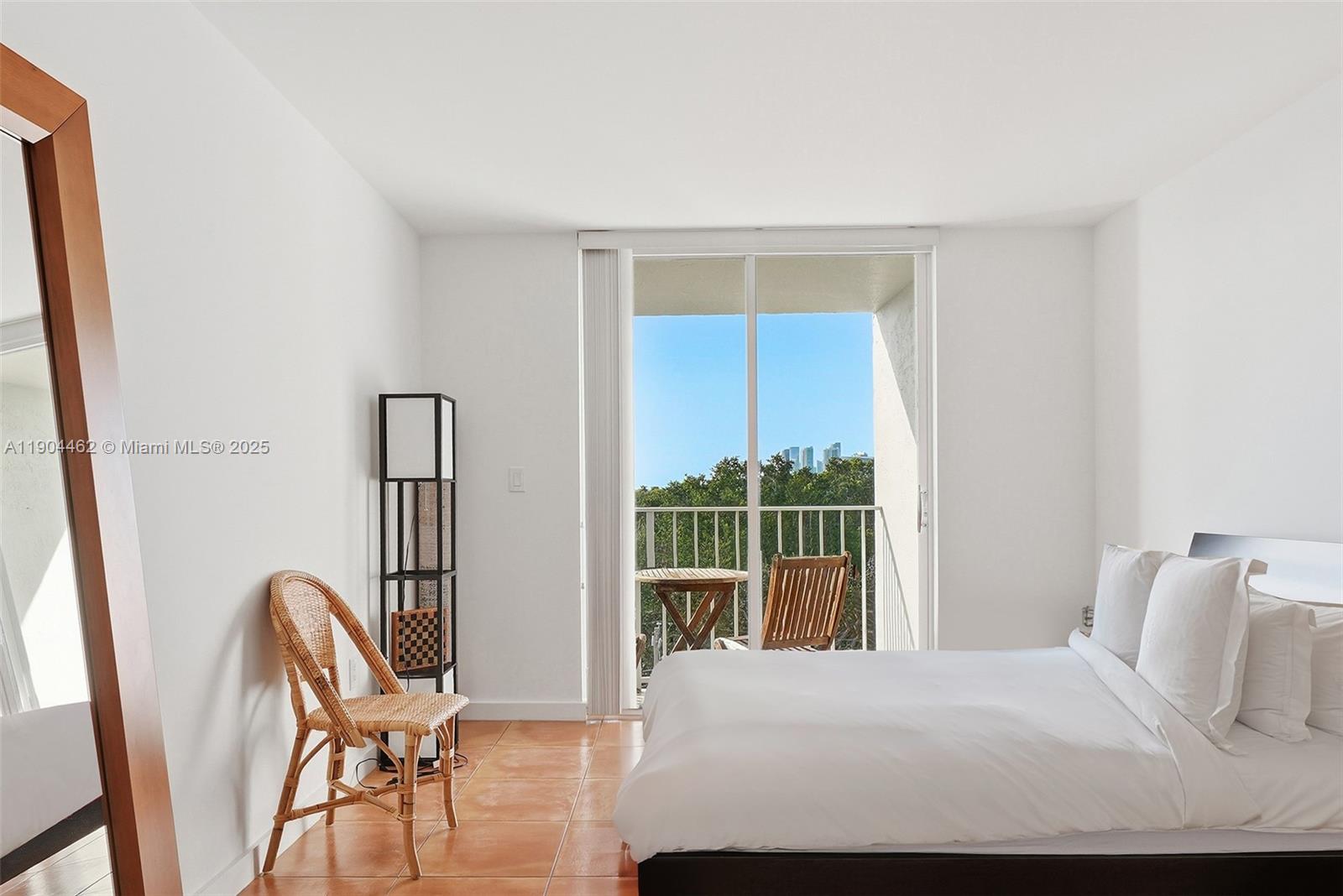 700 Northeast 63rd Street, Unit D607 Miami, FL 33138 - Photo 10 of 29 a bedroom with a bed and a large window