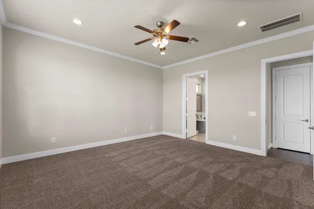 a view of an empty room with a ceiling fan