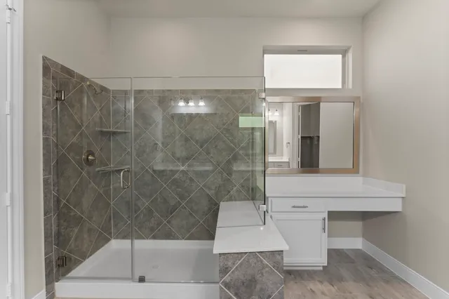 a bathroom with a shower and mirror