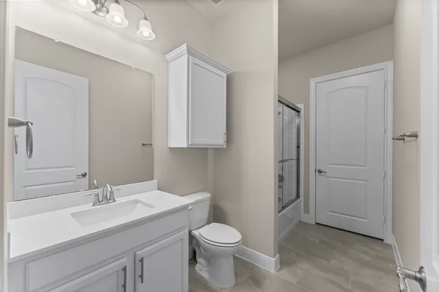 a bathroom with a sink toilet and vanity