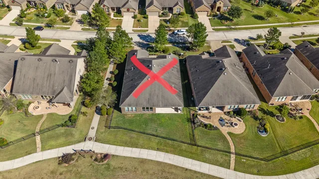 an aerial view of a house with a swimming pool