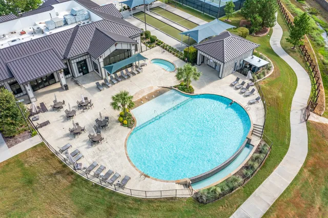 an aerial view of a house with a yard and potted plants