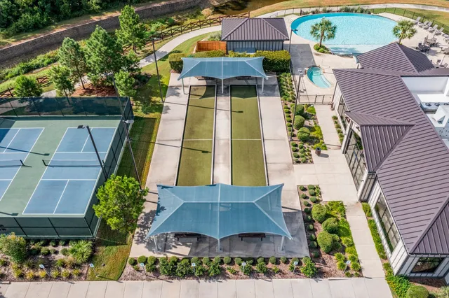 an aerial view of a residential houses with outdoor space and swimming pool