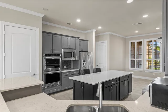 a kitchen with a stove a refrigerator and a sink