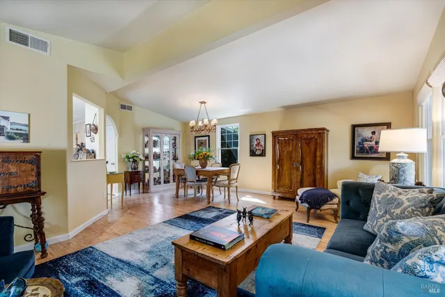 a living room with furniture a wooden floor and a flat screen tv