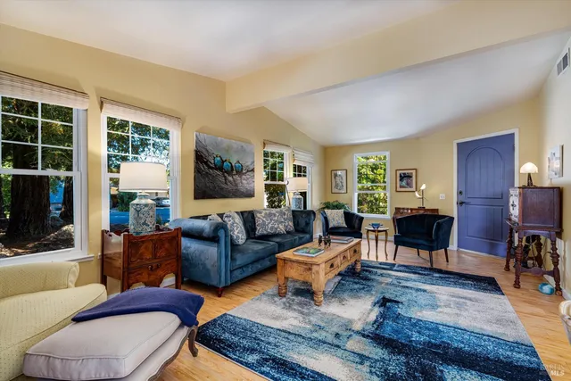 a living room with furniture wooden floor and a flat screen tv