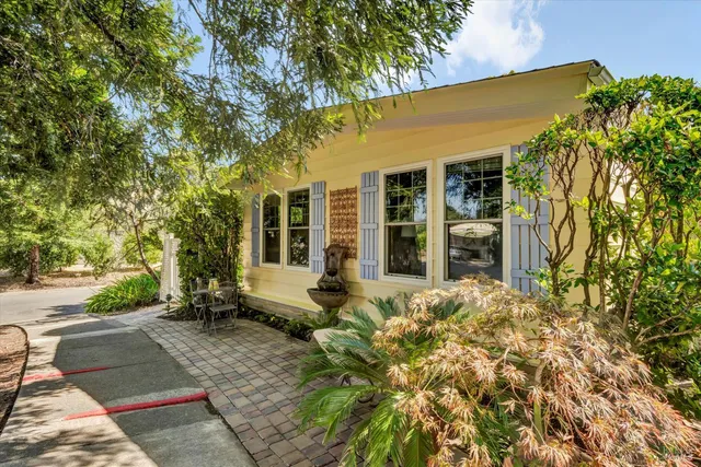 front view of a house with a large tree