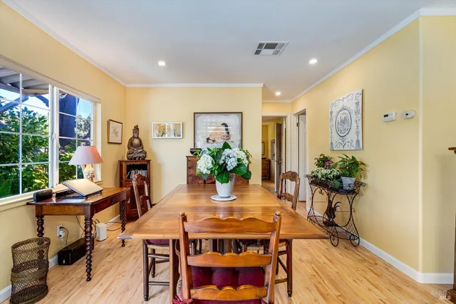 a view of a dining room with furniture window and wooden floor