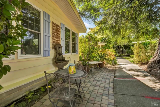 a view of a patio with table and chairs and potted plants