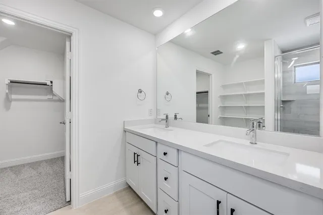 a bathroom with a double vanity sink mirror and double