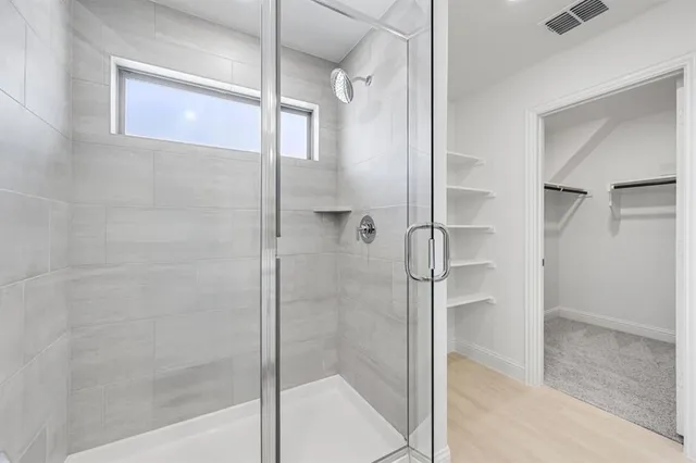 a bathroom with a glass shower door