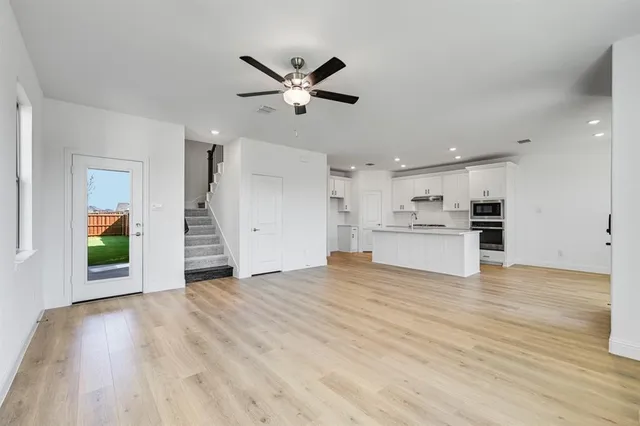 a view of a kitchen with a sink and a stove top oven