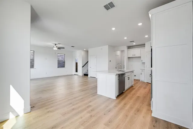 a view of kitchen with kitchen island and stainless steel appliances