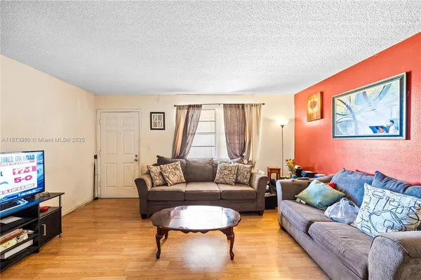 a living room with furniture and a flat screen tv