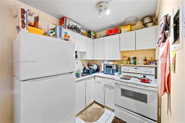 a kitchen with stainless steel appliances a refrigerator and a stove top oven