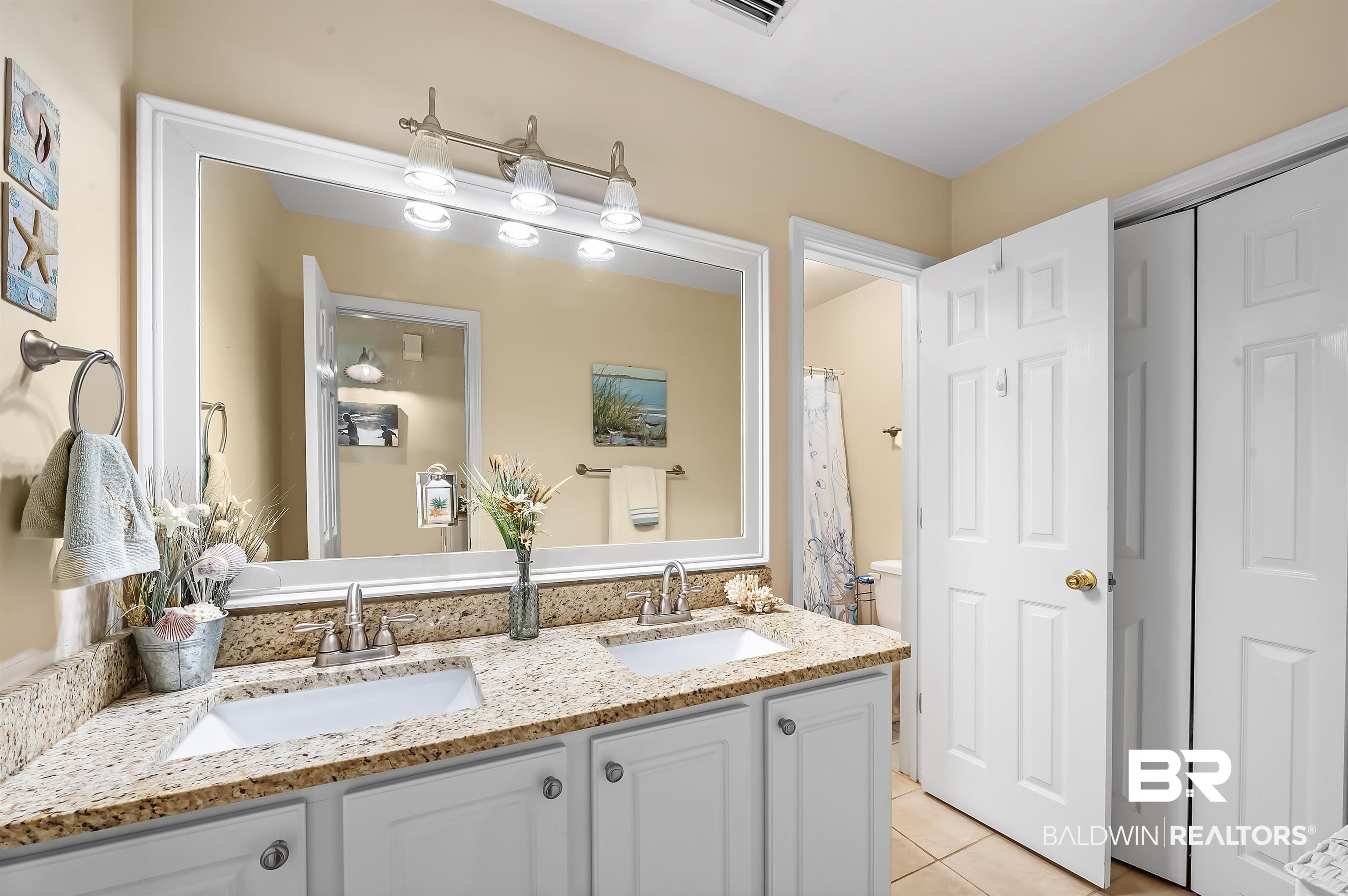 9901 Glover Court Fairhope, AL 36532 - Photo 28 of 52 Bathroom featuring vanity, toilet, and tile patterned floors