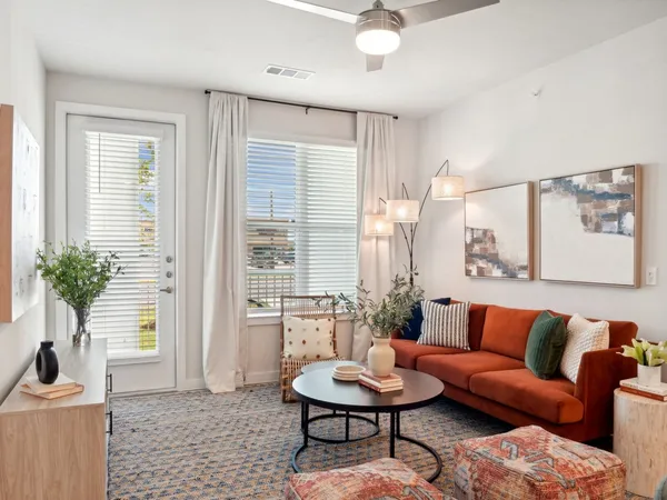 a living room with furniture and a potted plant
