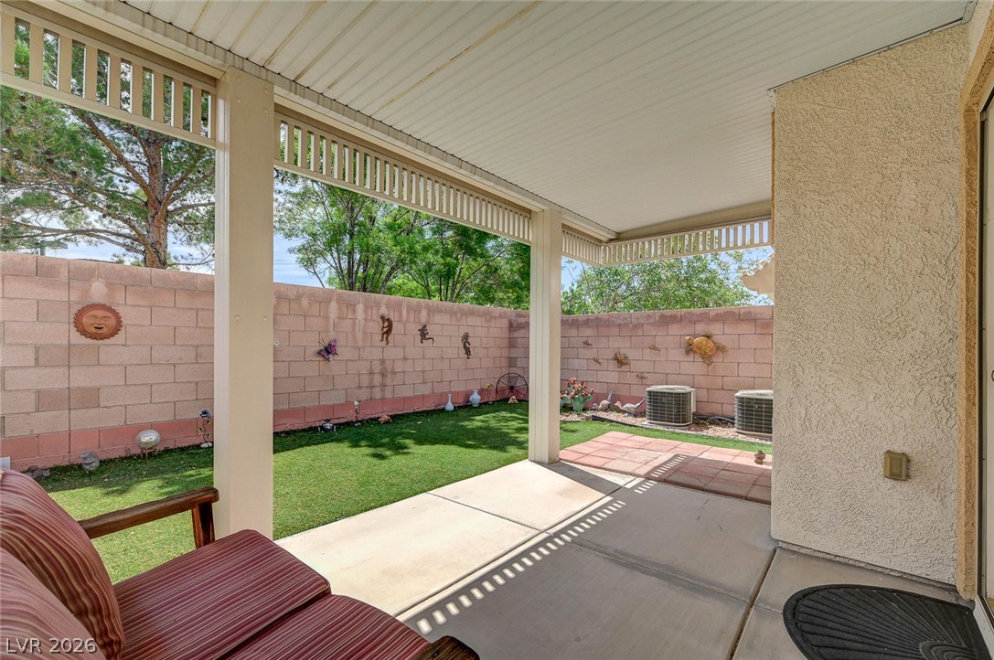 1479 Orange Jubilee Road Henderson, NV 89014 - Photo 33 of 36 A private backyard oasis features a covered patio and artificial turf.