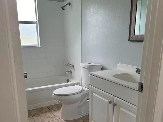 a kitchen with stainless steel appliances granite countertop a refrigerator a stove a sink and a microwave